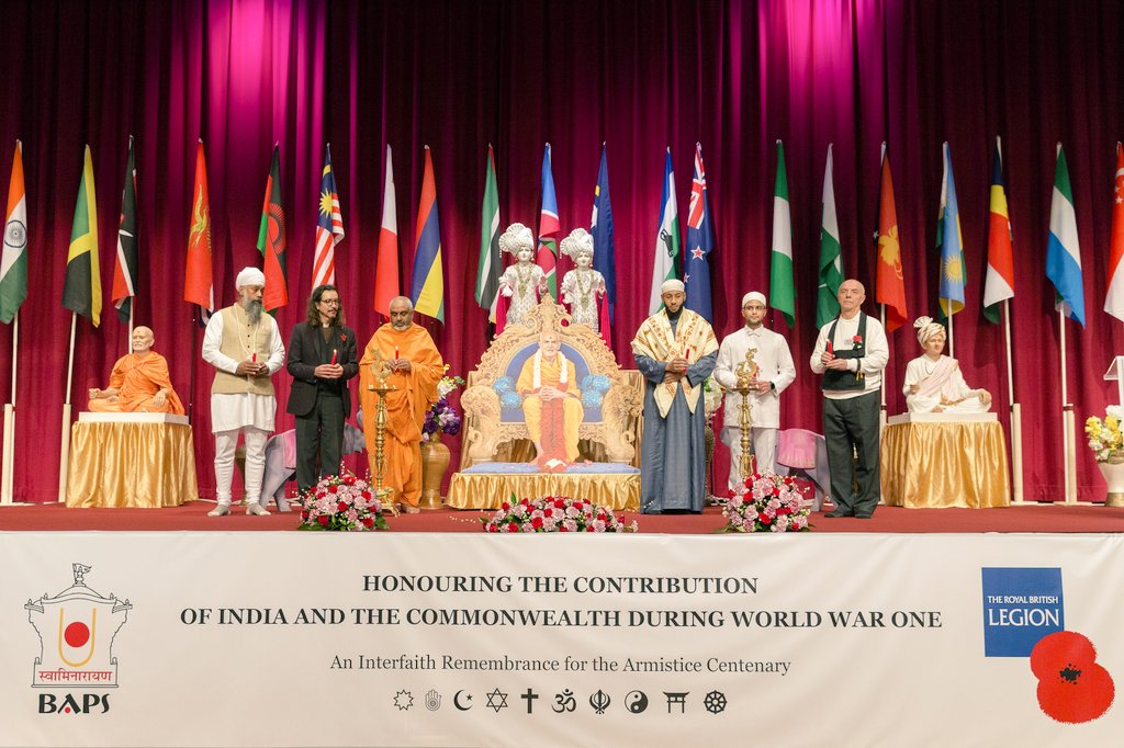 Leaders of different faiths stand on a stage