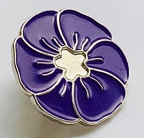 An enamel badge in the shape of a purple poppy